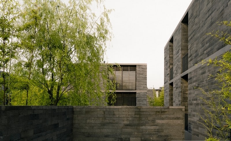 Apartment buildings surrounded by a water garden and wild landscape (4)