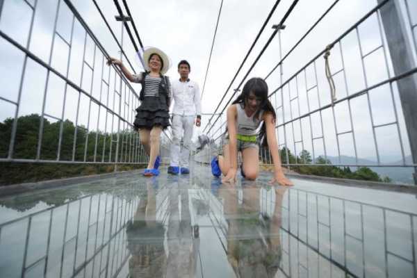 High-altitude suspension bridge made of glass opens in Hunan, China