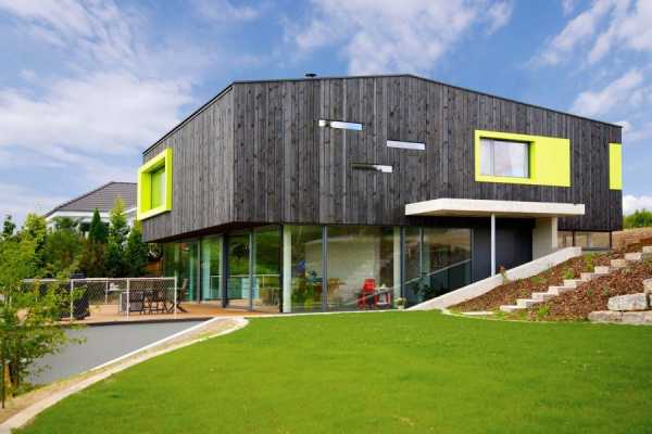 This German Family House is a Black Cuboid Supported by Glass Walls