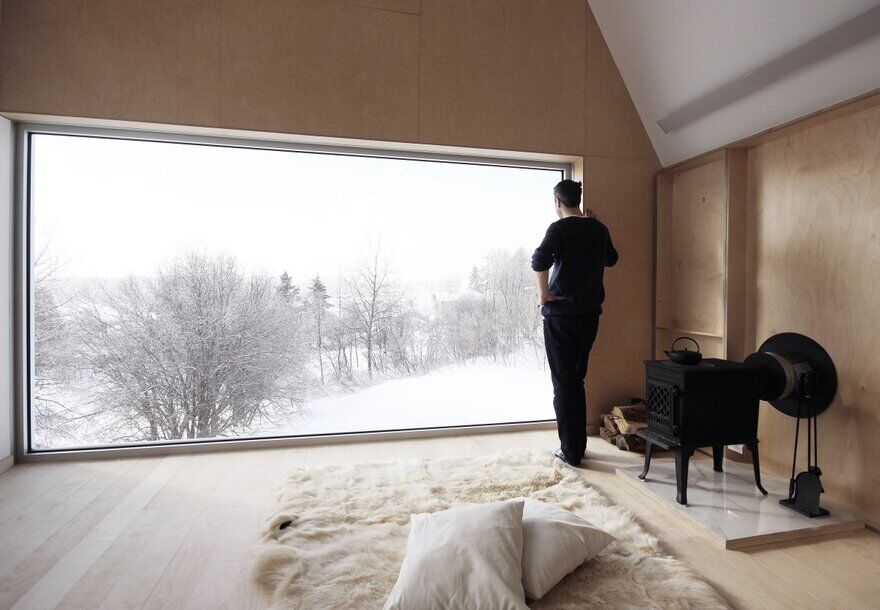 Winter Chalet on Stilts Rises Above a Snow-Laden Slope in Quebec