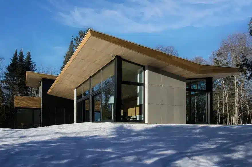 Wooden Wing Cottage in Quebec Perched on a Granite Bedrock