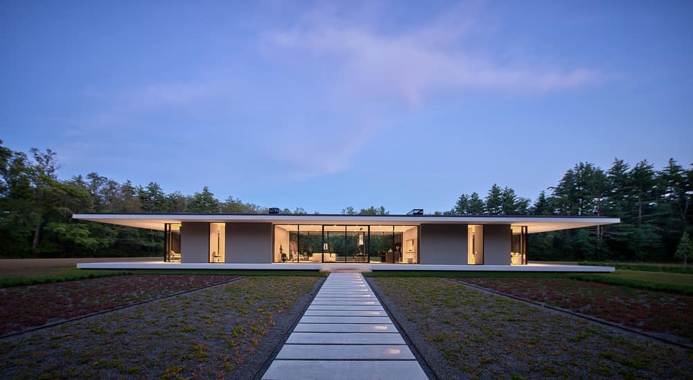 Minimalist Glass House Dots a 9 Acre Grass Field in Berkshires, MA